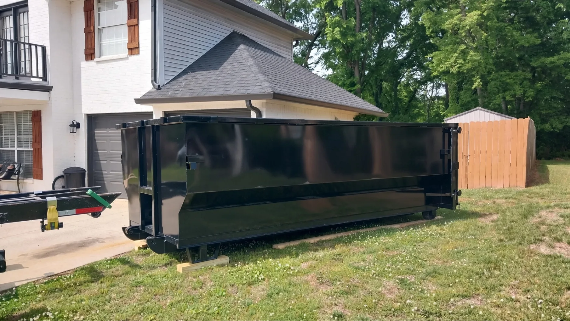 Same black dumpster blank before Waste Warriors wrap