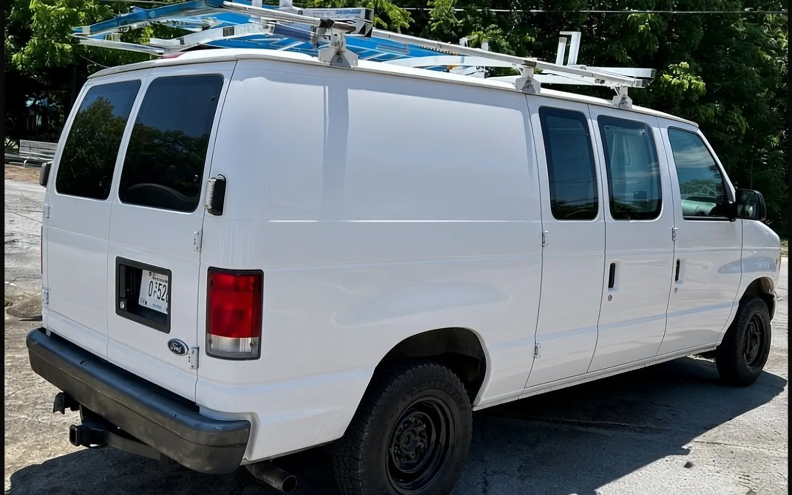 Same white cargo van before Real Deal wrap