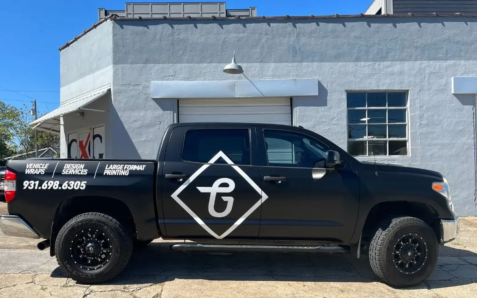 Graphix Garage matte black Tundra after full wrap with logo and services