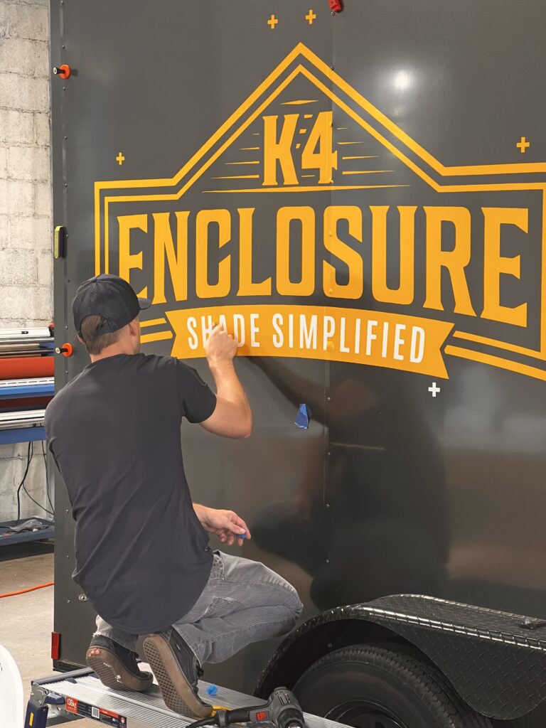 The team at Graphix Garage installing a custom decal.